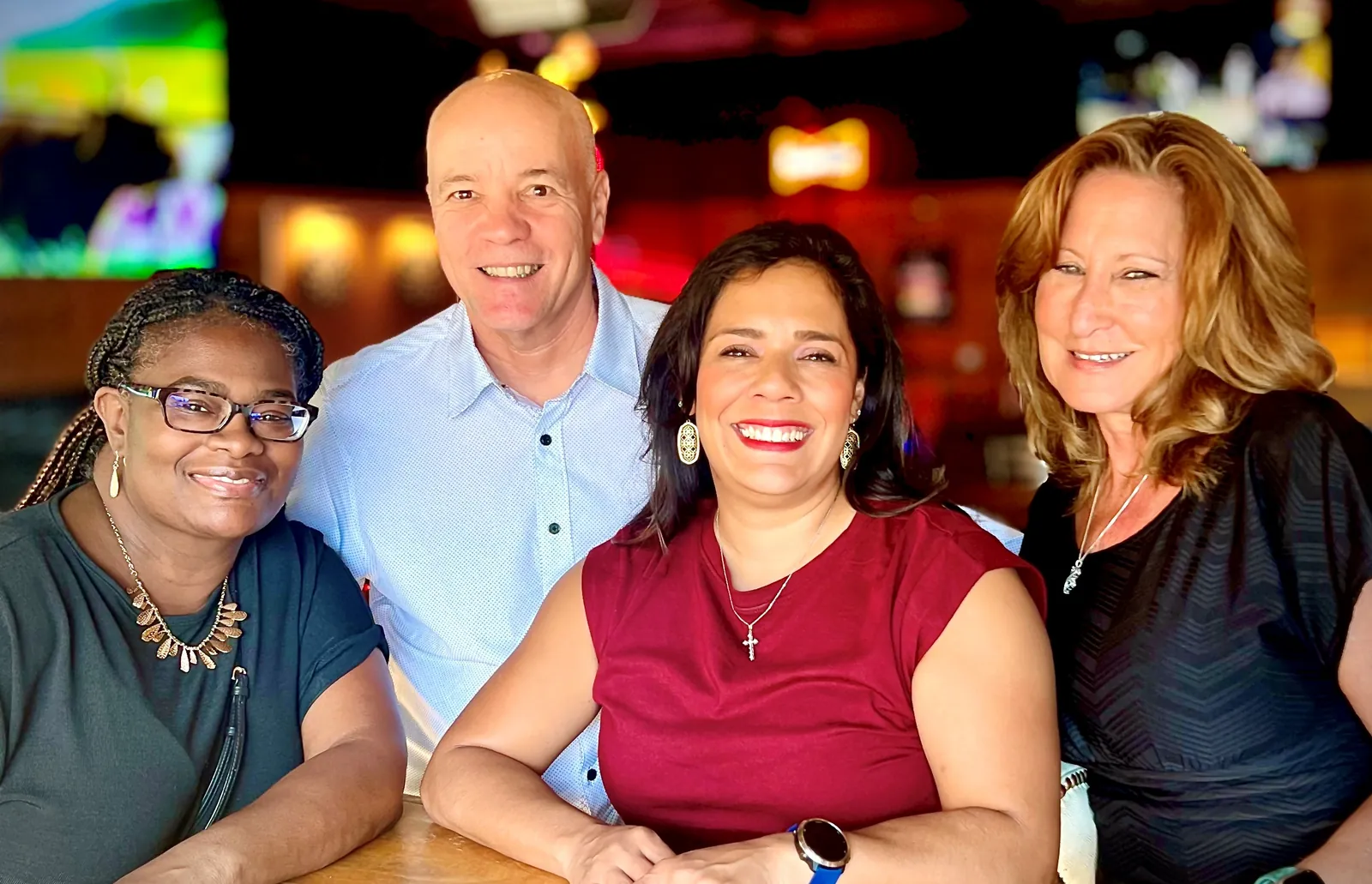 Four members of the Eckert Insurance Group team smiling together at an Austin gathering